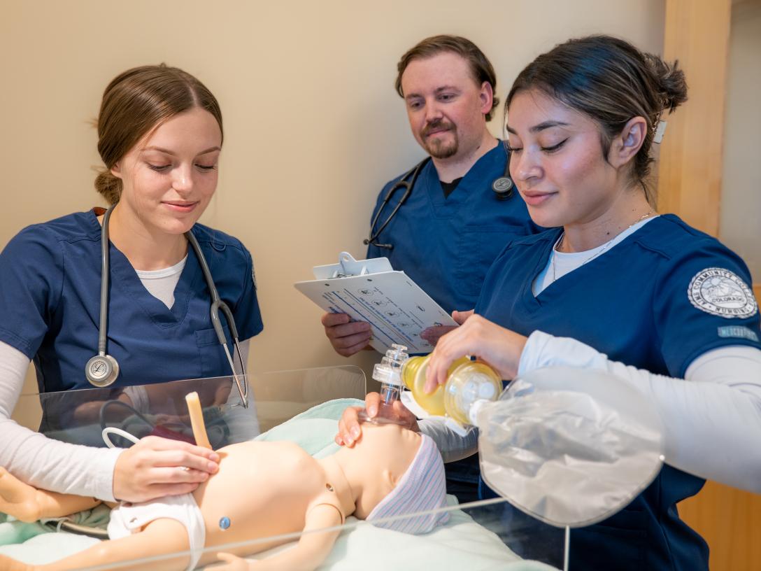Students with Baby manquin practicing nursing care