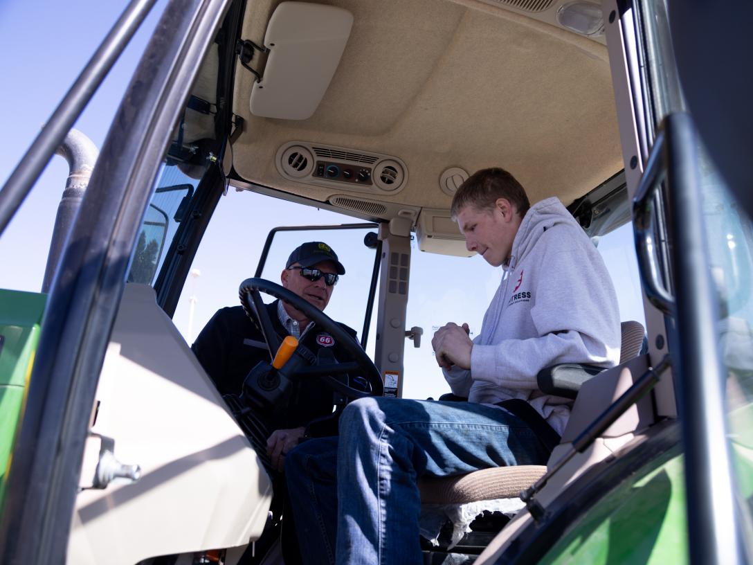 student and instructor talking in tractor