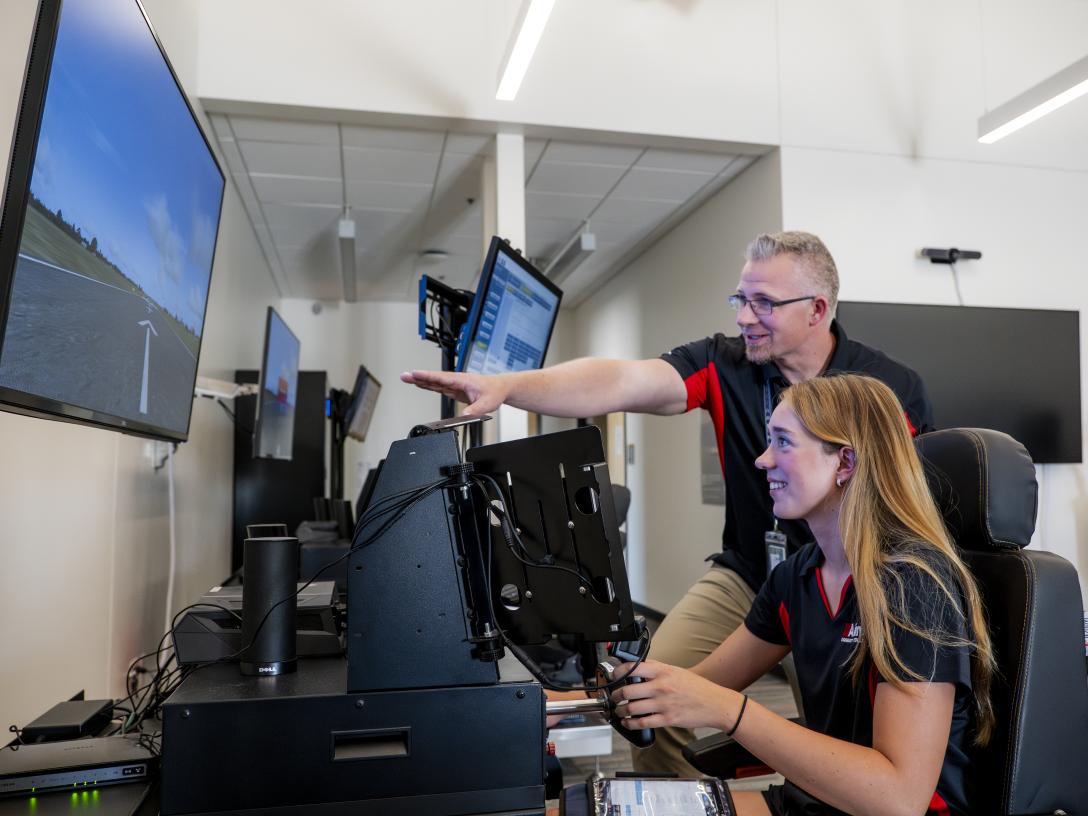 Samantha Walsh and instructor using flight simulator