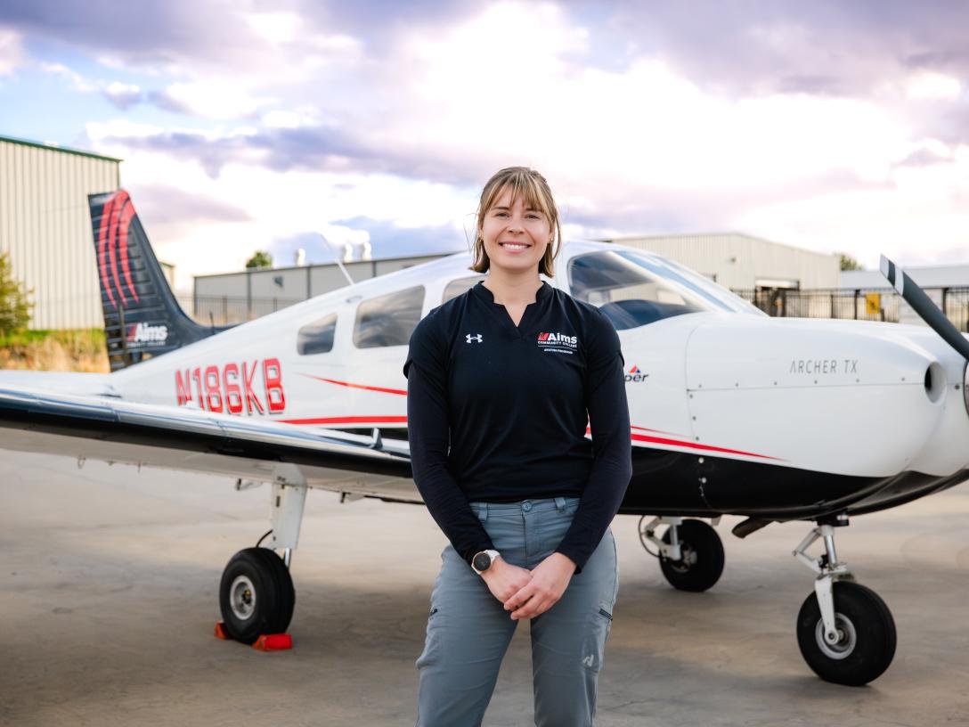 Sara Weaver in front of an airplane