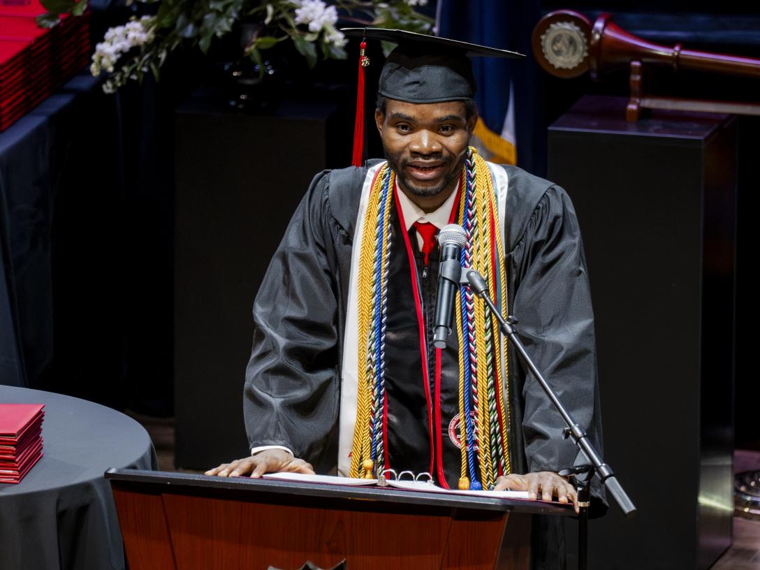 Egide Godonou speaking at behind a podium