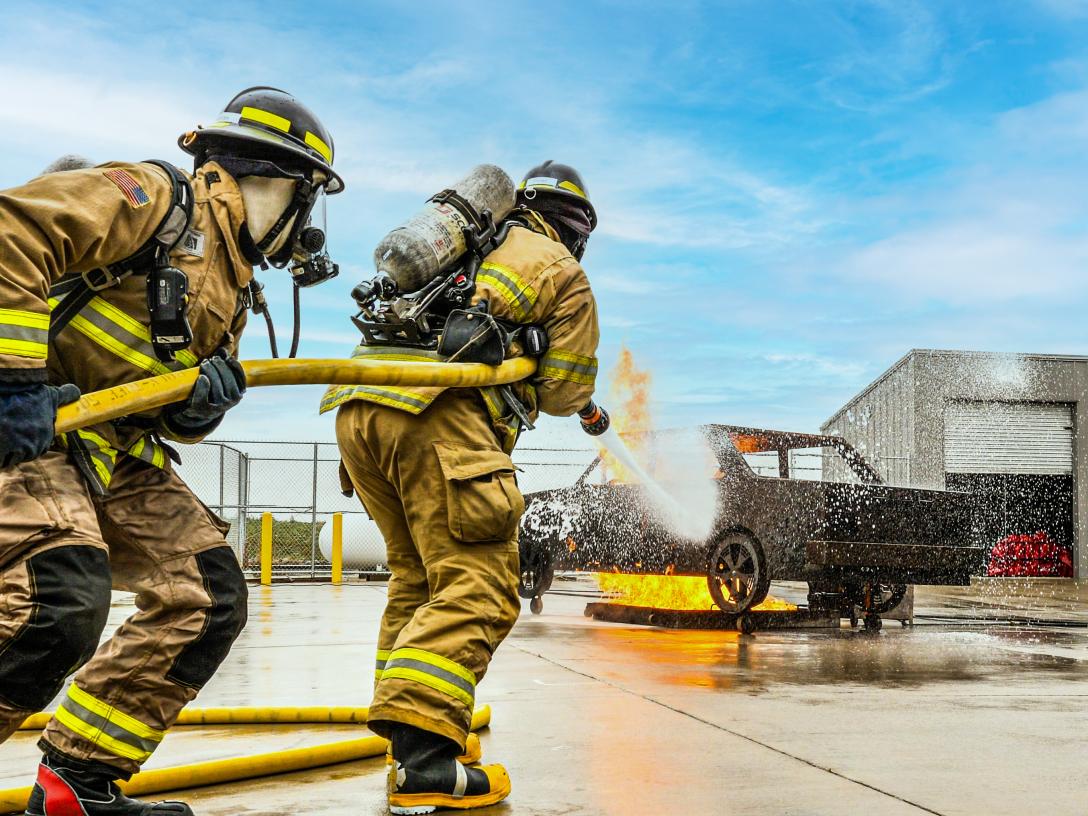 Aims Community College Fire Science students extinguishing a vehicle fire