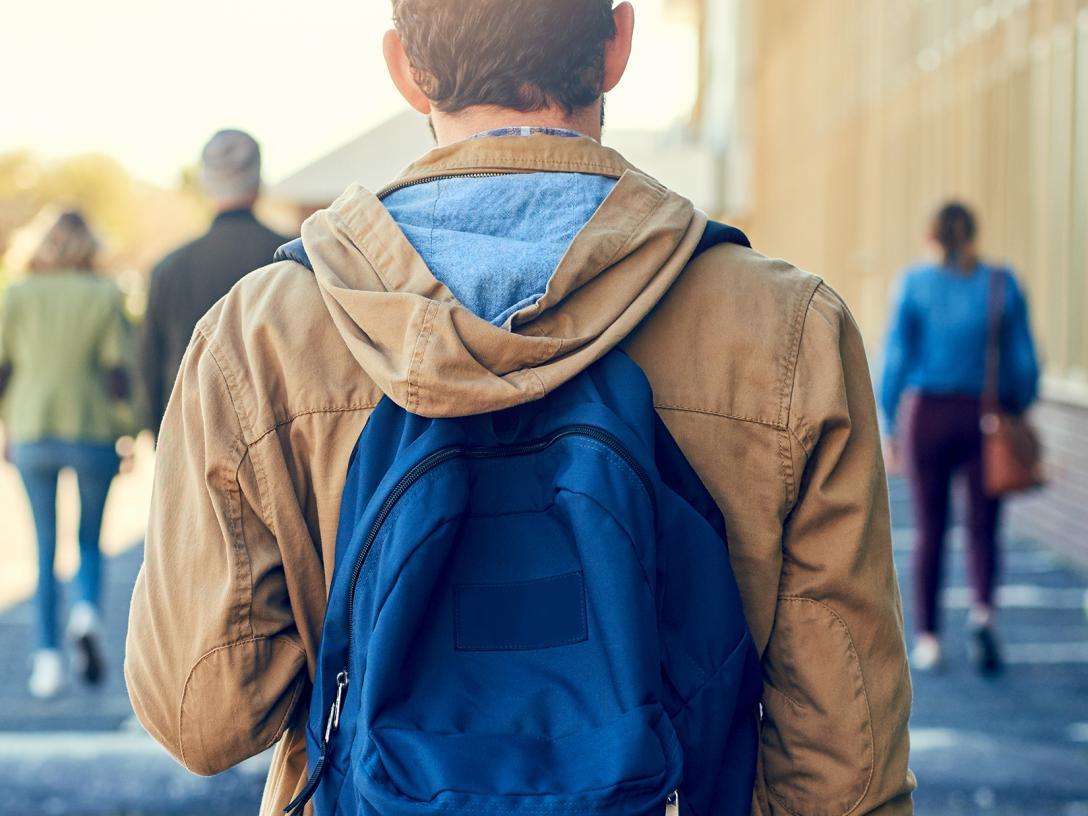 Student walking on Aims campus