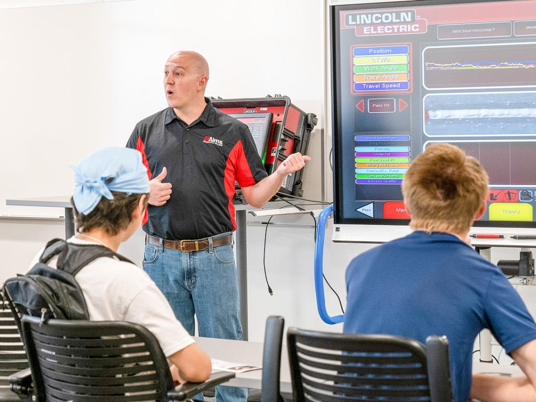 An Aims Community College professor teaches welding to a class of high school students.