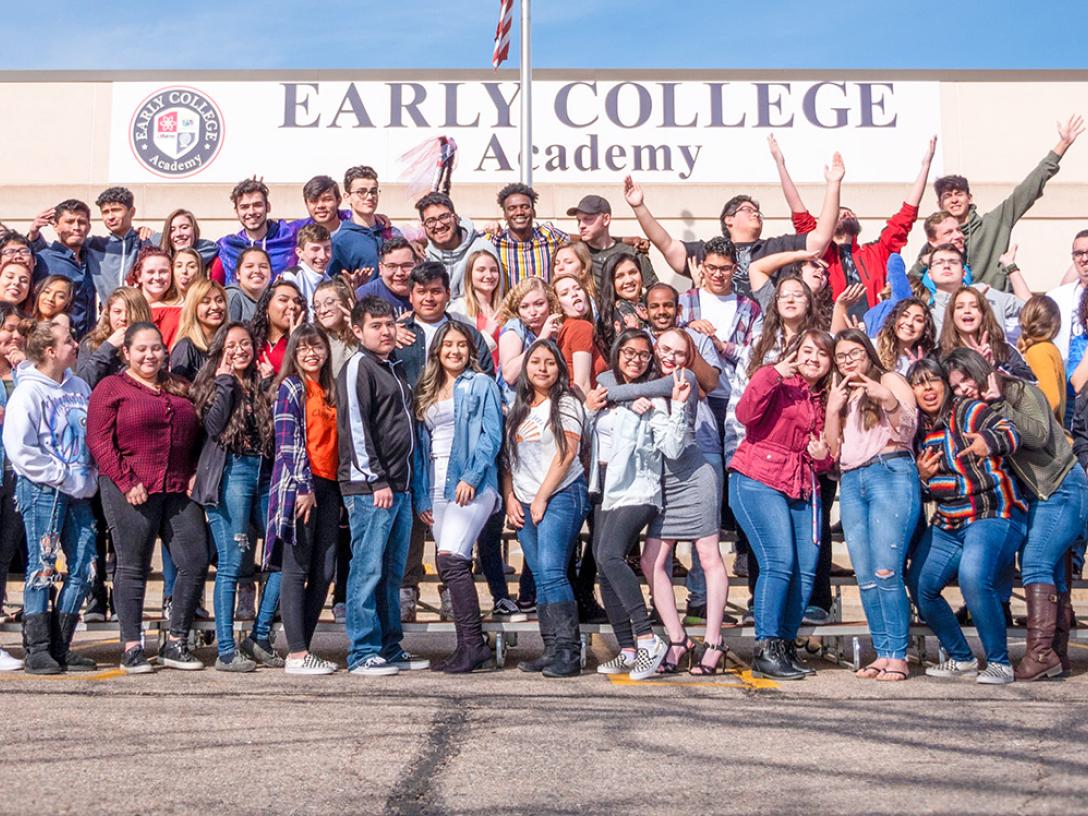 Early College Academy Students pose for a group photo outside of school.