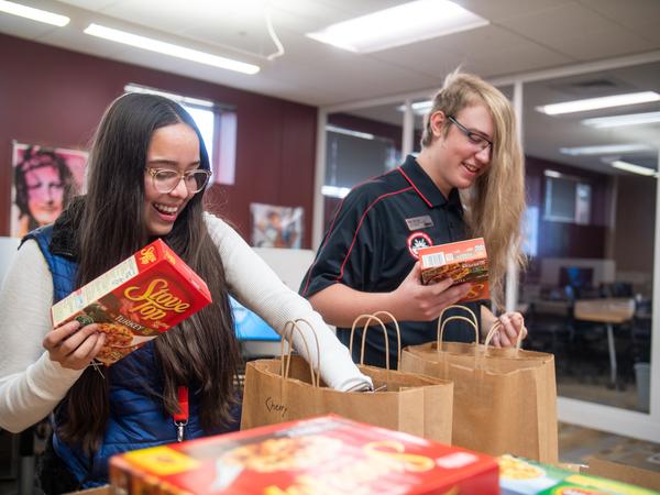 Students bagging Thanksgiving meal kits