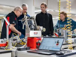 Instructor showing people through industrial technology lab