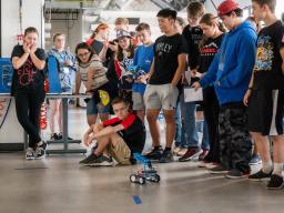 BEST Camp Robotic competition, student watching robot in action