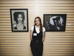 Aims Student Art Show artist with two of her pieces