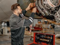 man repairing an airplane
