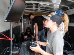 Kids using simulators in the mobile aviation lab