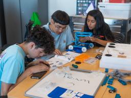 Students working on a project across the table. 