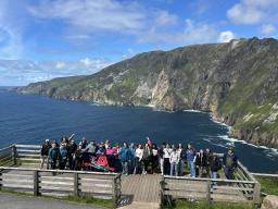 Study Abroad Group on Dock with water and hill