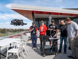 Aims UAS Students with flying drone on Welcome Center Patio