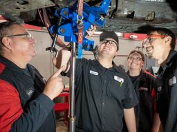Aims Automotive Students and Instructors under a lifted vehicle 