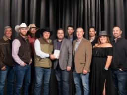 Group photo of Welcome Center project team with the award in hand. 
