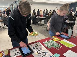Aims students signing up for event at table