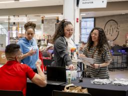 People at a booth at Discover Aims events