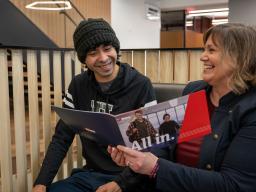 Admission Councilor showing student information in a book