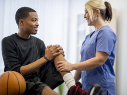 Doctor examining a student's knee