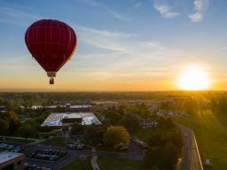 An aerial view of a hot air balloon over the Aims Community College campus