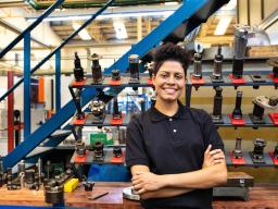 Person posing in front of tools and equipment 