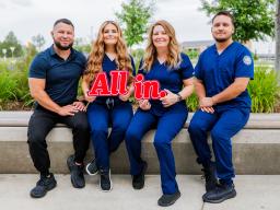 Lozano Family photo holding "All in" sign
