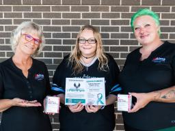 People holding narcan boxes and drug recovery information