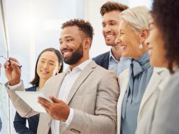 Group of Employees one writing on a white board