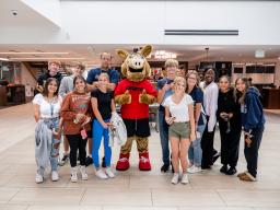 Aims Students posing with Arty the Aardvark mascot at the Student Commons