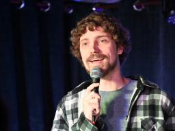 Von Sprecken speaking into a microphone