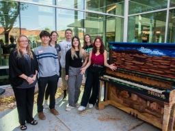 Aims student leaders at with a painted piano on campus