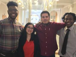 Four students smiling at camera