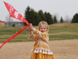 Young girl with red kite