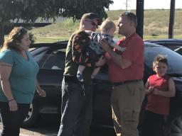 Man handing baby to Province
