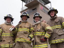 Four firefighters smiling at camera