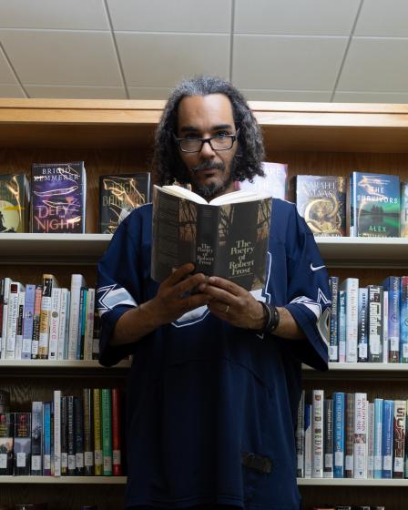 Jeremiah Oatman in Library with poetry book