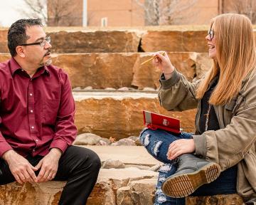 Hannah Tofflemoyer, Aims student, and Philosophy and Humanities professor, Daniel Alvarez talk in an outdoor classroom setting