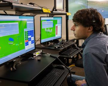 An Aims air traffic controller student using a computer