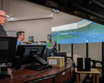 An Aims instructor and student in an air traffic controller classroom