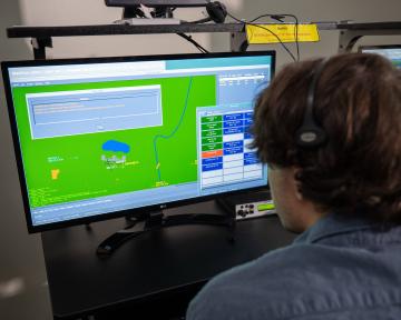 A student practices on a computer in the Aims air traffic controller degree program