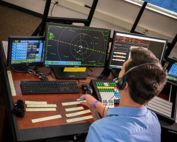 A student practices on a computer in the Aims air traffic controller degree program