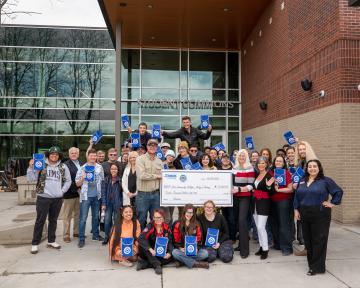 Atmos Energy Donation Ceremony Group photo with big check