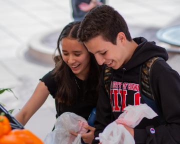 Students looking at food on Farm to Families Food Truck