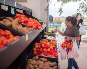 Farms to Families Food Truck with student choosing veggies