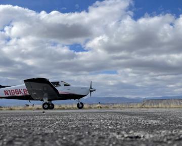 Aims Airplane on Runway with Cloudy Sky