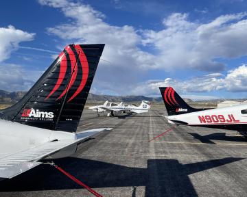 Aims branded Airplanes on Runway showing the plane tails