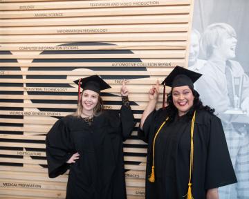 Graduates posing in caps and gowns