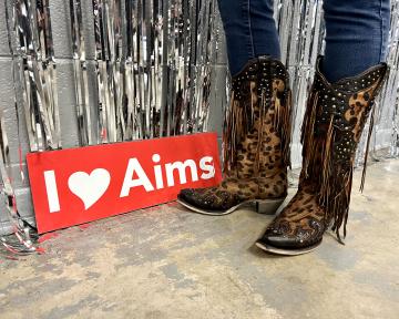 Animal print cowboy boots with I love Aims sign