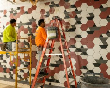 People working on the tile in the Gateway Building